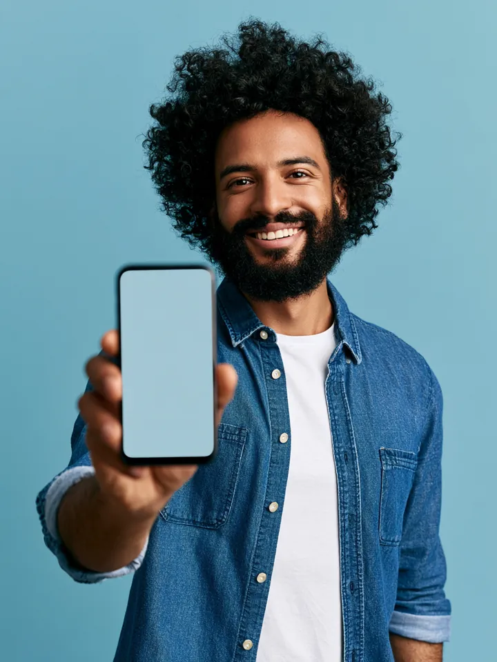 Man holding a smartphone toward the camera, representing a Happy Money loan request completed on a phone